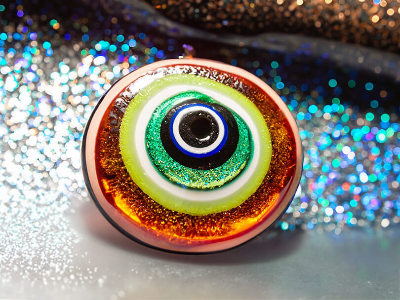 Close-Up View Of A Sparkling Multicolored Evil Eye Amulet