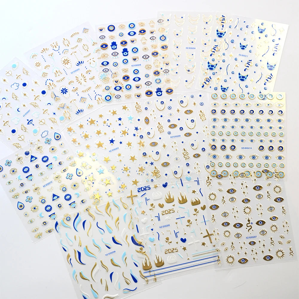 Six sheets of blue and gold-tone evil eye nail stickers with eye, star, moon, snake, and Hamsa motifs