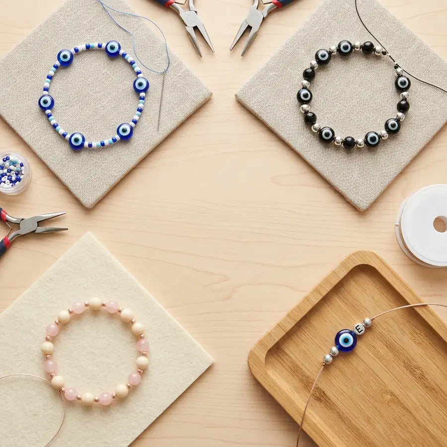 Four separated bracelet variation zones showing classic blue-white, black-silver, pink-cream, and initial charm design choice