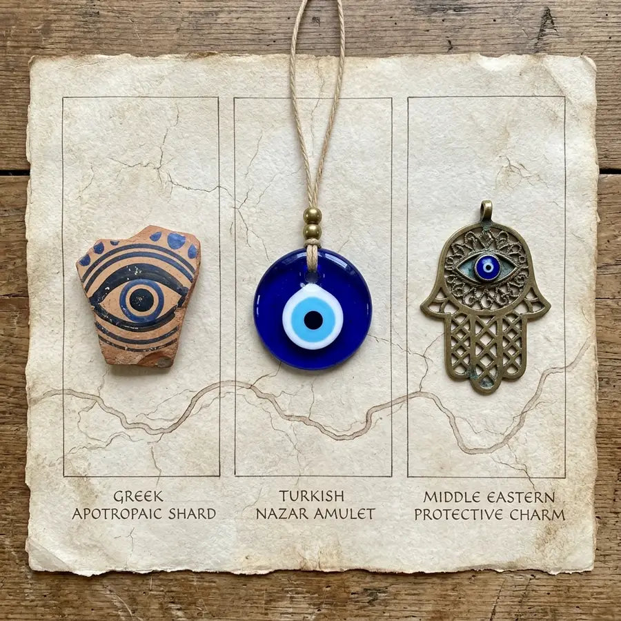 Three equal panels comparing a Greek ceramic gaze motif, Turkish nazar bead, and Middle Eastern protective charm connected by