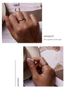 Hands wearing a 925 sterling silver adjustable evil eye ring