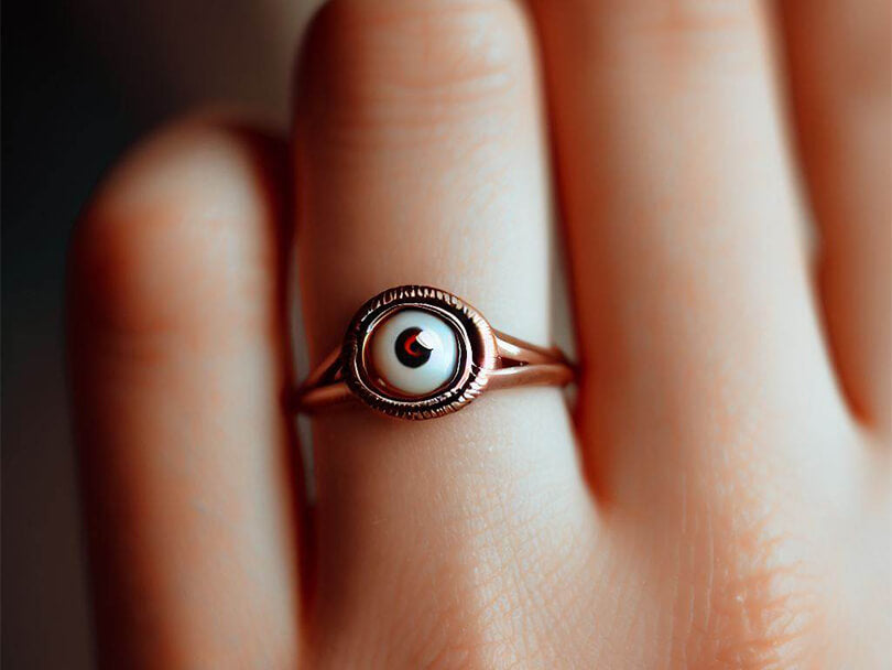Hand Wearing A Brown Evil Eye Ring
