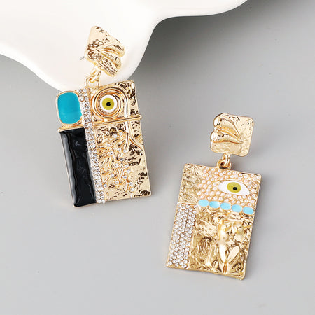 Gold and black earrings with evil eye