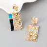 Gold and black earrings with evil eye