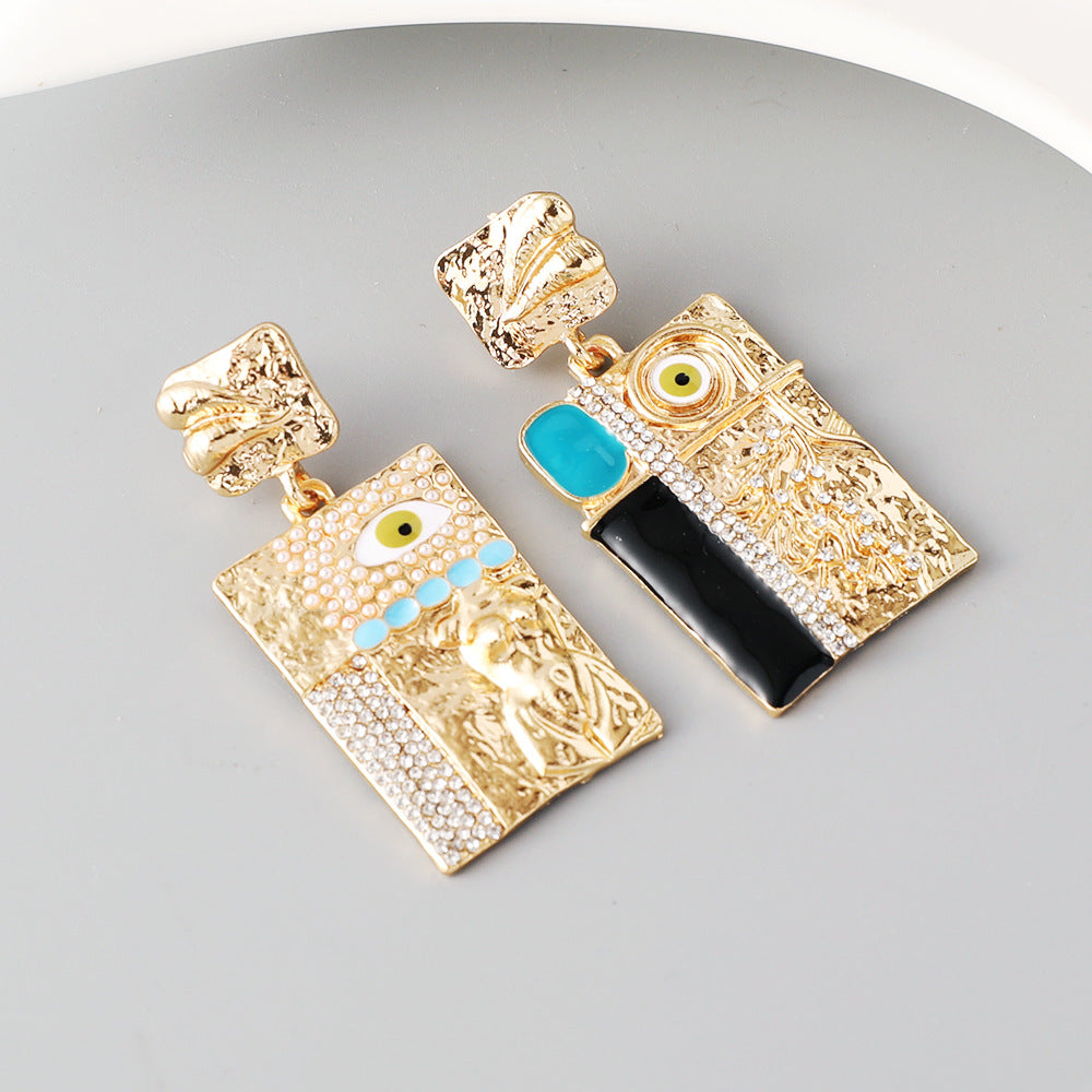 Gold evil eye earrings with turquoise and black accents