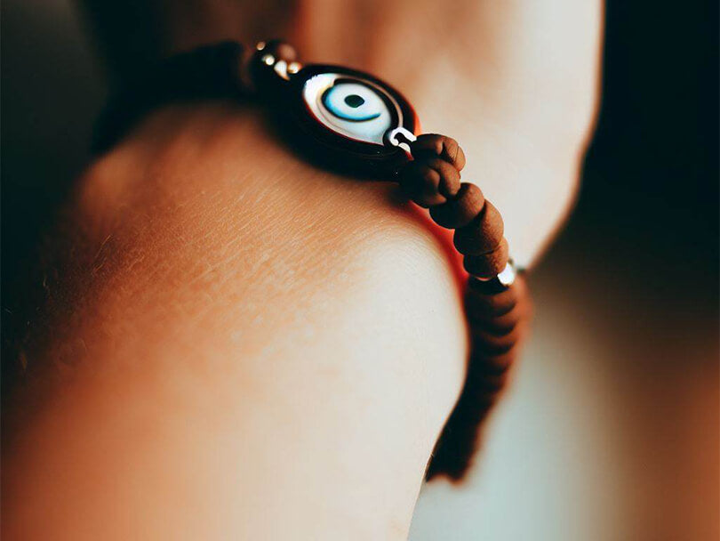 Person Wearing A Brown Evil Eye Bracelet