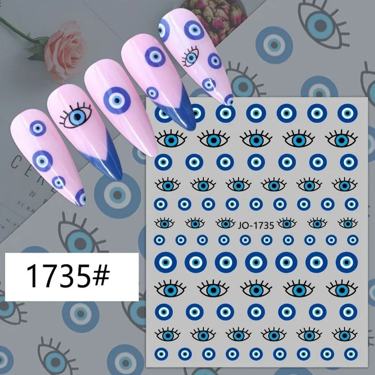 Blue evil eye circle nail stickers displayed on pink manicure samples