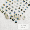 Nail art stickers featuring blue and black evil eye designs with gold outlines, shown on a textured white background with several sample nails decorated.