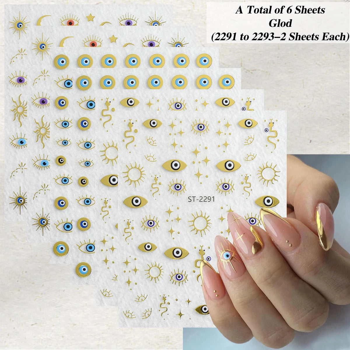 Six sheets of gold and blue evil eye nail stickers with sun and moon designs, shown next to a hand with manicured nails decorated with the stickers.