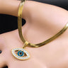 Open Eye necklace in gold tone displayed across a hand, showing the blue-centered pendant and flat chain