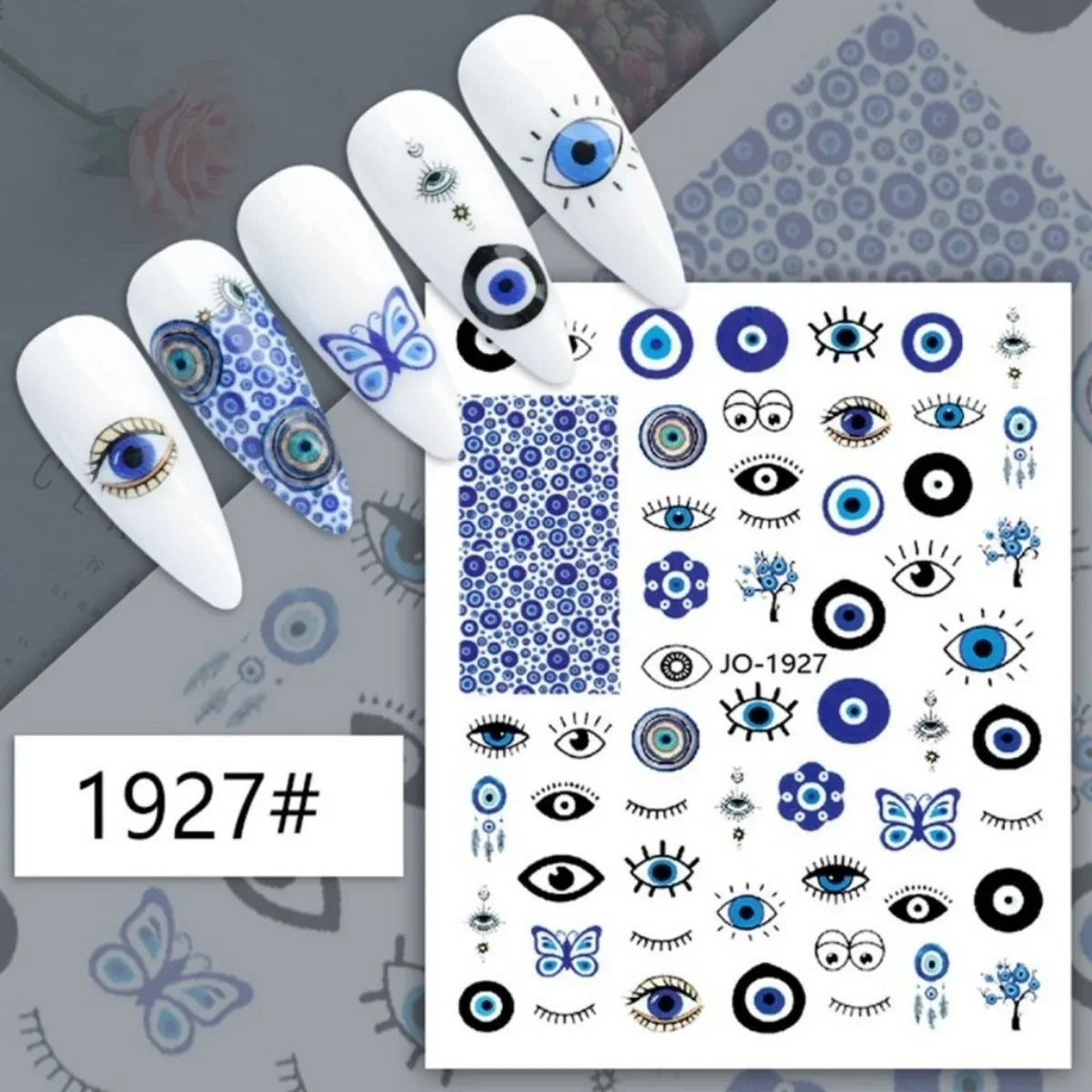 Blue evil eye and butterfly nail stickers displayed on white manicure samples
