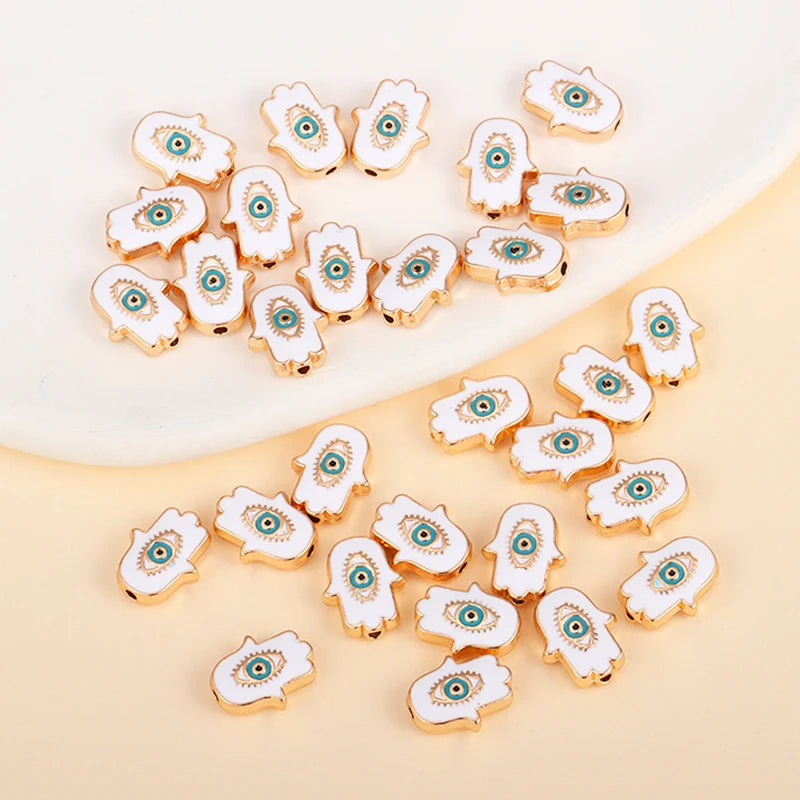 White Hamsa-shaped evil eye charm beads