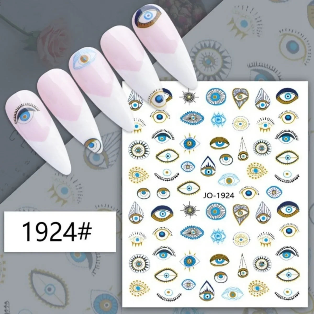 Blue and gold-tone eye motif nail stickers displayed on pink manicure samples