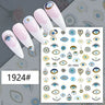 Blue and gold-tone eye motif nail stickers displayed on pink manicure samples