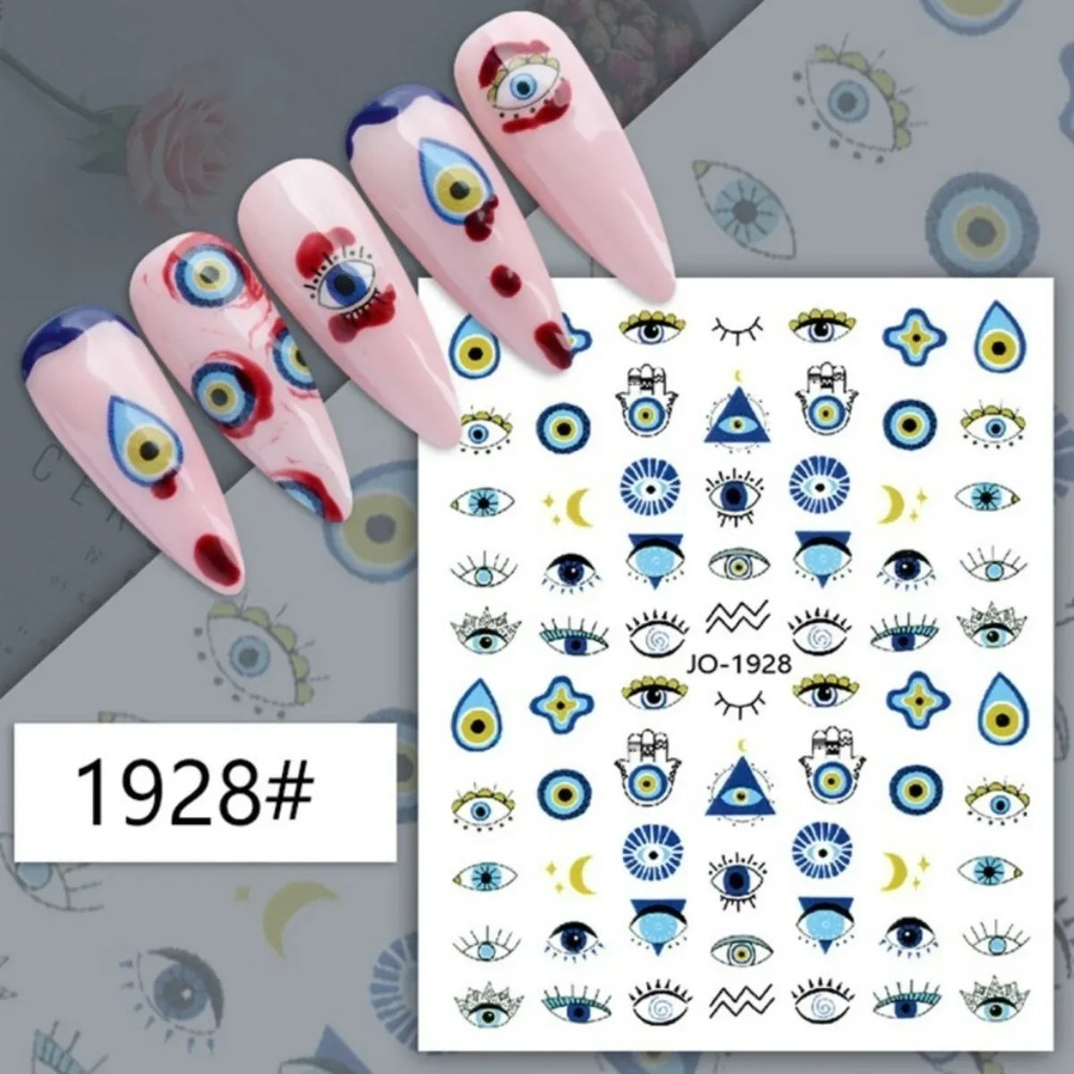 Blue and gold-tone eye and Hamsa nail stickers displayed on pink manicure samples