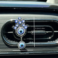 Silver tone Hamsa clip with a vertical annotation reading 6.2 cm / 2.44 in and a horizontal annotation reading 3.6 cm / 1.42 in.