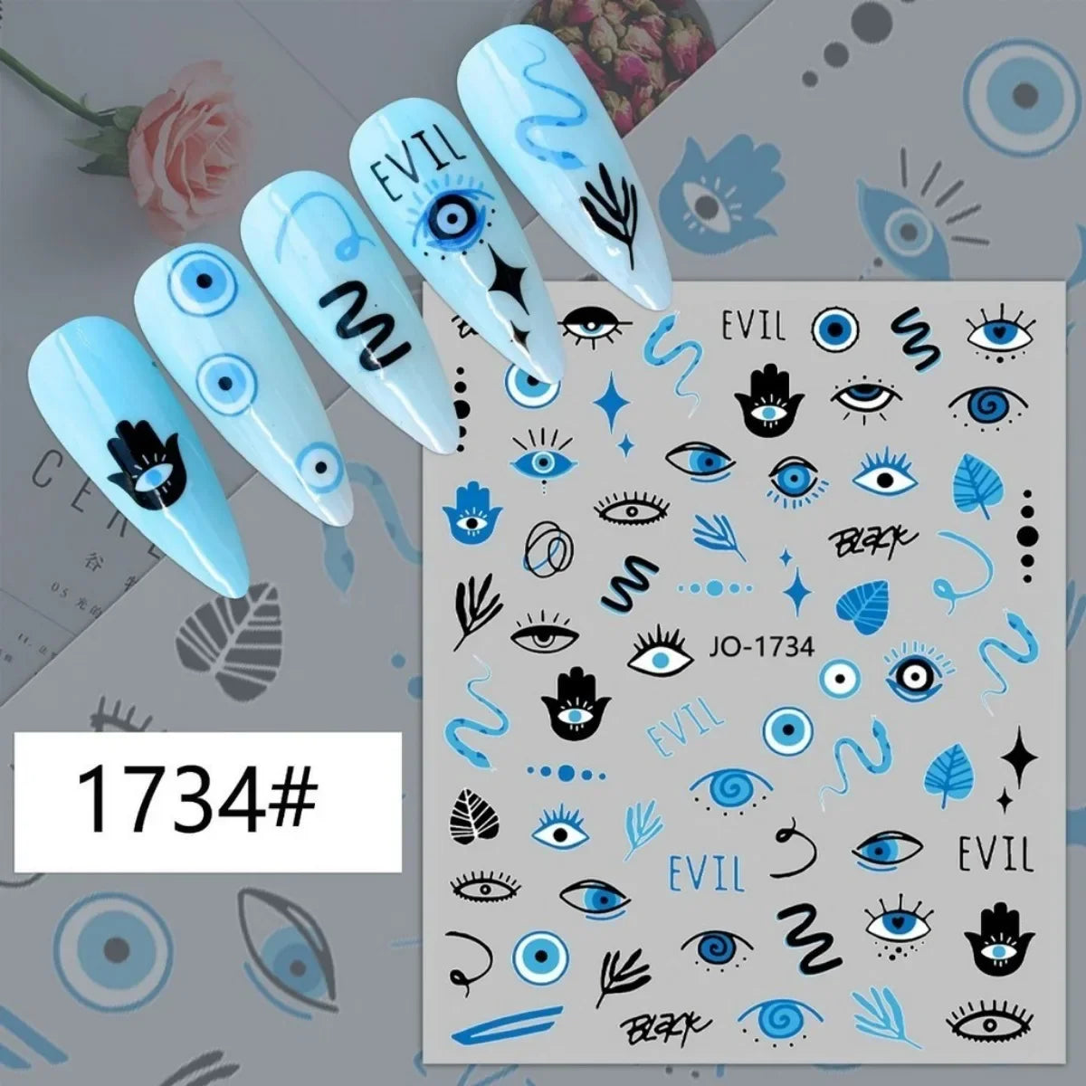 Blue, black and white eye motif nail stickers displayed on pale blue manicure samples