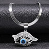 Curved Brow necklace in silver tone with a sweeping clear-accented brow above an open eye design and blue center