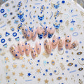 Blue and gold-tone 3D evil eye nail stickers shown across six manicure designs