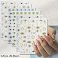 Six sheets of nail art stickers featuring gold and blue evil eye designs, shown with a hand displaying manicured nails decorated with matching stickers.