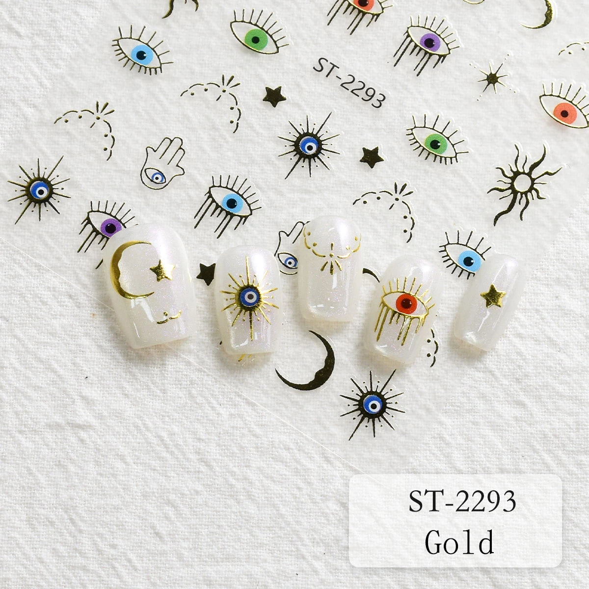 Five white press-on nails decorated with gold crescent moons, stars, and evil eye designs, displayed on a white textured background with matching nail decals. The text 'ST-2293 Gold' is visible in the bottom right corner.