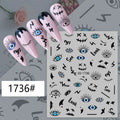 Black and blue graphic eye nail stickers displayed on pink manicure samples