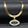 Close-up of the Open Eye necklace in gold tone, with a flat chain, clear eye outline and blue center accents