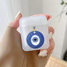 Handheld frosted earphone case with an illustration of a blue circular eye pendant and a small yellow loop.