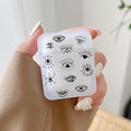 Handheld frosted earphone case with assorted black line drawings of eyes and lashes.