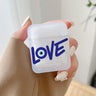 Handheld frosted earphone case with blue LOVE lettering and an eye motif inside the letter O.