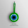 Front view of the Green evil eye charm with a bright green border and loop surrounding white and turquoise blue rings and a black center.