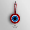Front view of the Red evil eye charm with a red border and loop surrounding white and turquoise blue rings and a black center.