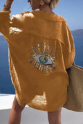 Back view of a mustard yellow shirt with a sequin eye motif and curved hem
