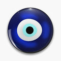 Round deep blue button pin with a white eye ring, turquoise inner ring and black center.