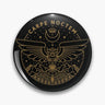 Black round button pin with gold tone Carpe Noctem lettering, an outstretched owl, mountains, stars and a crescent moon.