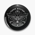 Black round button pin with white Carpe Noctem lettering, an outstretched owl, mountains, stars and a crescent moon.