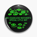 Black round button pin with bright green eyes and the words The Ceaseless Watcher's Special Little Boy.