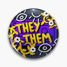 Round purple and black button pin with yellow They Them lettering, white eyes and flowers.