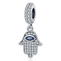 Silver tone Hamsa dangle with a dark blue almond-shaped eye, clear accents across the hand and a decorated bail