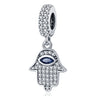 Silver tone Hamsa dangle with a dark blue almond-shaped eye, clear accents across the hand and a decorated bail