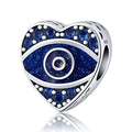 Silver tone heart bead with a speckled blue eye, blue faceted accents and a visible side opening