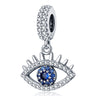 Silver tone open eye dangle with upper lashes, a blue center, clear accents and a decorated bail