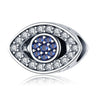 Silver tone open eye bead with a round blue center, clear border accents and a visible side opening