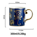 Navy blue Namaste lotus coffee cup with a gold tone handle, shown with measurement arrows and printed capacity and weight annotations.