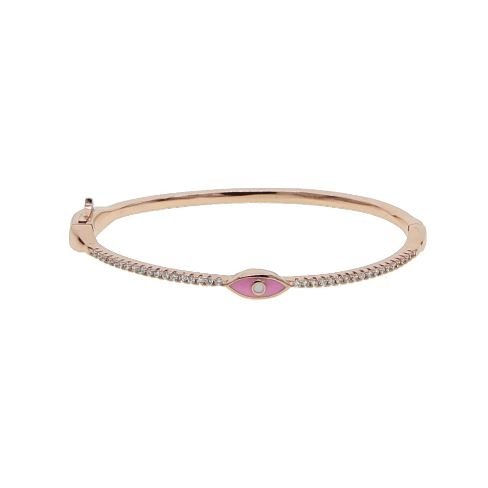 Rose gold tone bangle with a pink eye, white center and clear front accents