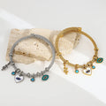 Gold tone and silver tone evil eye bangles side by side with snake and heart charms