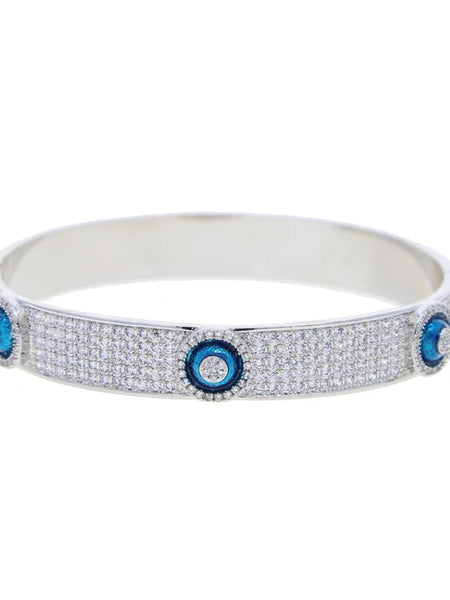 Silver tone evil eye bangle with rows of clear accents and raised blue eye discs
