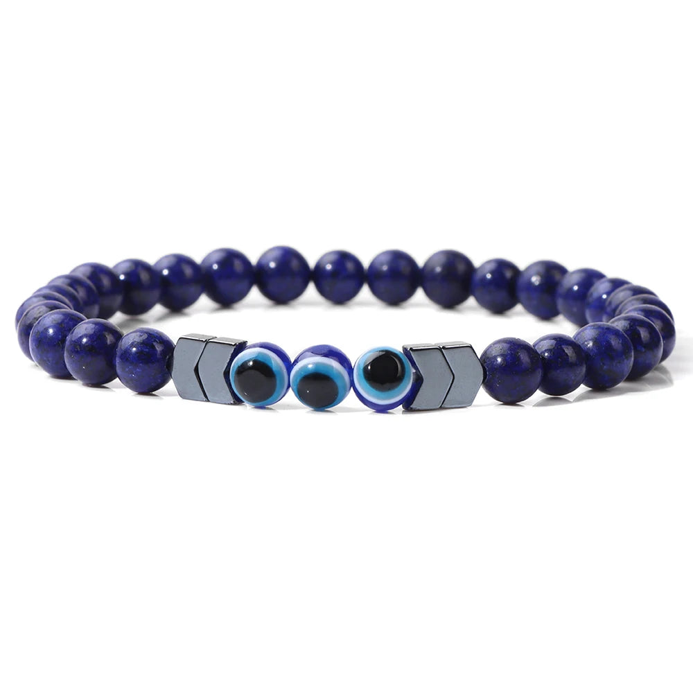 Deep blue beaded bracelet with three blue eye beads and silver tone chevron spacers