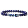 Deep blue beaded bracelet with three blue eye beads and silver tone chevron spacers