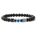 Glossy black beaded bracelet with three blue eye beads and reflective chevron spacers